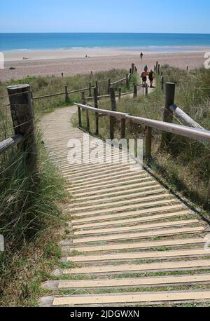 Littlempton, West Sussex, UK. A boarded footpath runs through the sand dunes behind West beach. Stock Photo