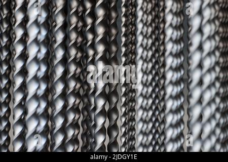 Bunch of hammer power drill bits in hardware store background, small depth of field. Power impact drill bits for working with concrete and metal surfa Stock Photo