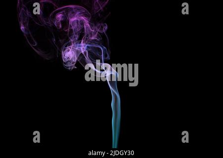 Multicolored smoke for aromatherapy and relaxation on black background, beautiful swirled puffs of smoke. Pink, purple and turquoise gradient colors o Stock Photo