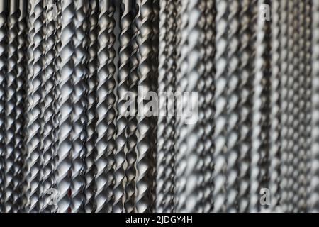 Bunch of hammer power drill bits in hardware store background, small depth of field. Power impact drill bits for working with concrete and metal surfa Stock Photo