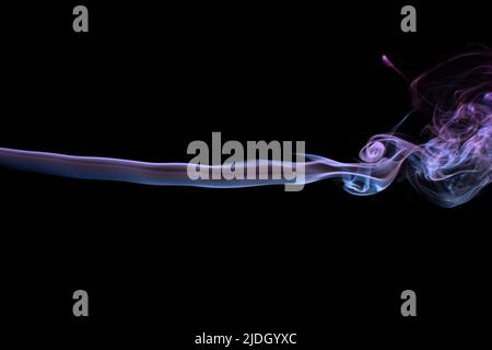 Multicolored smoke for aromatherapy and relaxation on black background, beautiful swirled puffs of smoke. Pink, purple and turquoise gradient colors o Stock Photo