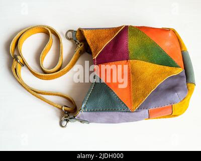 handcrafted patchwork cross body bag hand sewn from suede and leather on white background Stock Photo