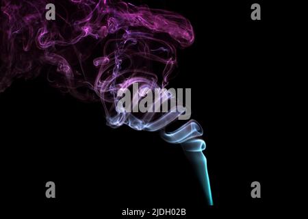 Multicolored smoke for aromatherapy and relaxation on black background, beautiful swirled puffs of smoke. Pink, purple and turquoise gradient colors o Stock Photo