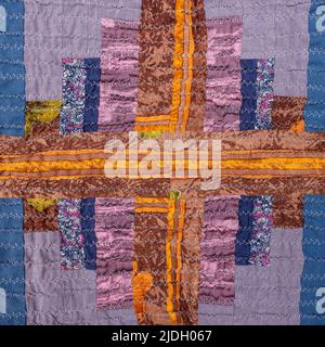 decor of handcrafted crinkled silk patchwork scarf with geometric pattern close up Stock Photo