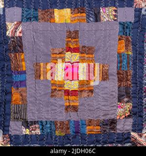 ornament of handcrafted crinkled silk patchwork scarf with geometric pattern close up Stock Photo