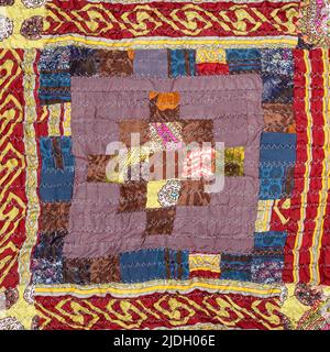 pattern on handcrafted crinkled silk patchwork scarf with geometric pattern close up Stock Photo