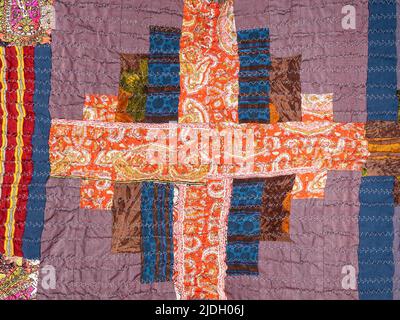detail of handcrafted crinkled silk patchwork scarf with geometric pattern close up Stock Photo