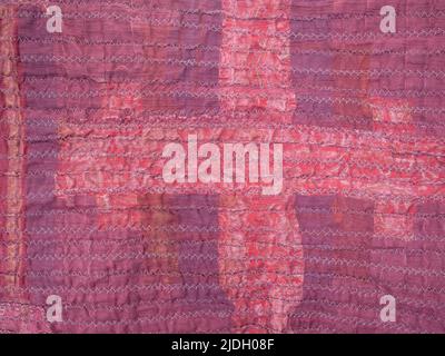 crinkled surface of back side of handcrafted red silk scarf Stock Photo
