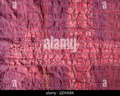 stitched back side of handcrafted crinkled red silk scarf close up Stock Photo