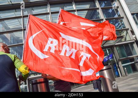 London, UK. 21st June 2022. RMT union members hold flags outside St Pancras International Station, as the biggest nationwide rail strike in 30 years hits the UK. Credit: Vuk Valcic/Alamy Live News Stock Photo