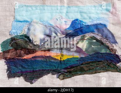 mountain landscape hand-sewn on canvas from various textile pieces Stock Photo