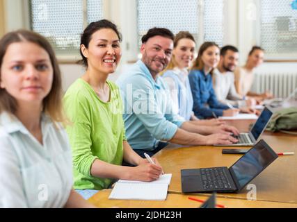 Group students listening and writing during business course Stock Photo
