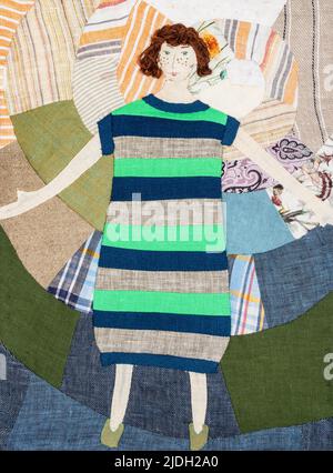 embroidered woman in striped dress on handcrafted patchwork pillowcase Stock Photo