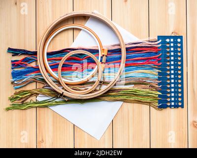 top view of embroidery kit with various hoops on wooden planks Stock Photo
