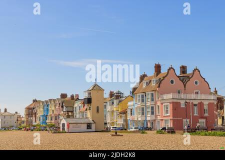 Colourful buildings facing the beach on a sunny day with blue sky. Aldeburgh, Suffolk. UK Stock Photo