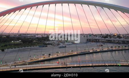 Aerial drone top view to Dubai canal and the Tolerance bridge on sunrise, United Arab Emirates, Middle East Stock Photo