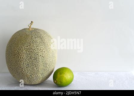 Melon and lime fruits on white background Stock Photo