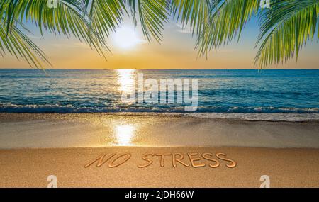 No stress concept with tropical beach and written text in the sand. Stock Photo