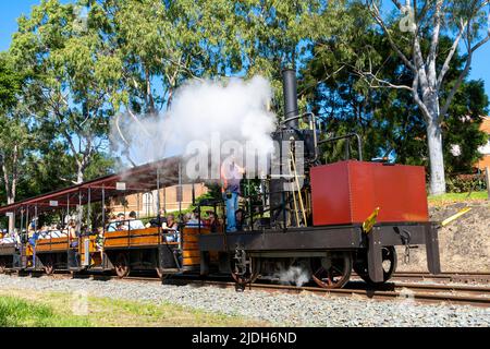 Passengers riding the Mary Ann replica steam locomotive in Maryborough Queensland, Australia Stock Photo
