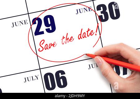 29th day of June. Hand drawing red line and writing the text Save the date on calendar date June 29.  Summer month, day of the year concept. Stock Photo