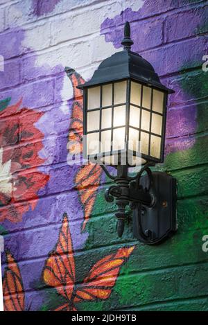 Illuminated Carriage Lamp - Painted Brick Wall - Lexington, Kentucky Stock Photo