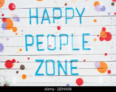 Text in English Happy people zone on white wooden plank background. Food and catering concept. invitation cafe marketing promotion. Barbecue in Garden sign outside restaurant Stock Photo