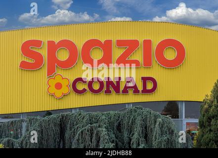 Cuneo, Italy - June 03, 2022: Conad Spazio logo sign on blu cloudy sky in the shopping center Grande Cuneo , Conad (National Retail Consortium) is the Stock Photo