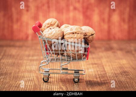 Shopping cart full of walnuts.Vitamins, shopping in the store. Stock Photo