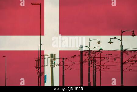 Denmark flag with tram connecting on electric line with blue sky as background, electric railway train and power supply lines, cables connections and
