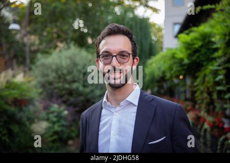 Portrait of a smiling caucasian businessman in elegant suit outdoors Stock Photo