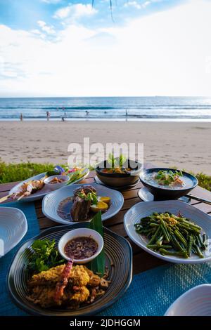 The lunch box with traditional Thai dish - grilled seafood, rice, fresh  vegetables and fruits, on the beach of Khai Nai island, Phuket, Thailand  Stock Photo - Alamy