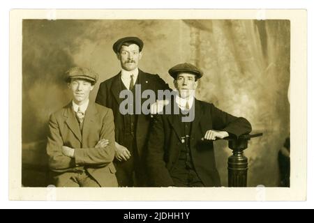 Original and clear early 1900's studio portrait group of 3 working class men wearing flat caps, possibly a WW1 enlistment photograph of friends, studio of Photographer, Cuttriss, Neville Street, Newcastle-on-Tyne, U.K.   circa  1914-1919, Stock Photo