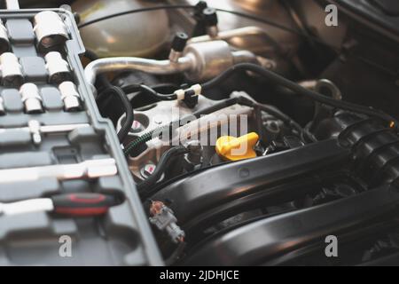 A set of socket wrenches lies on the car engine in the engine ...