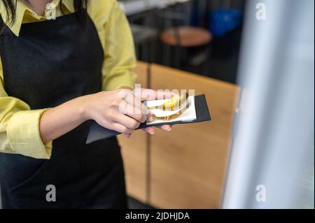 Womans hands holding cutlery in napkin Stock Photo