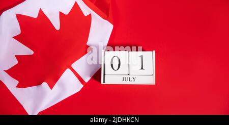 Canada Day, July 1 concept with Canadian flag on red Stock Photo