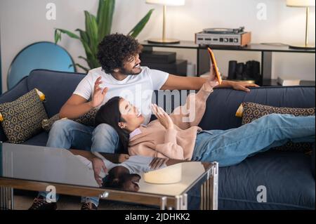 A cute young couple spending time at home and looking relaxed Stock Photo