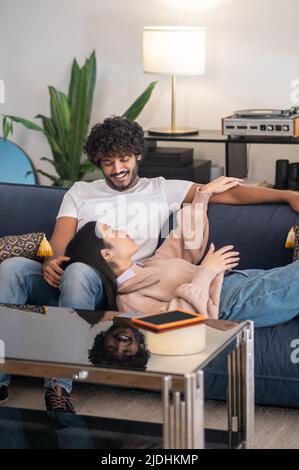 A cute young couple spending time at home and looking relaxed Stock Photo