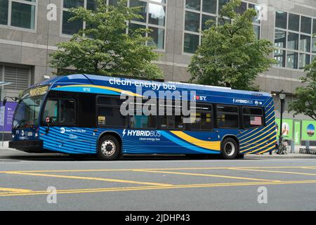 A hybrid bus that runs both off of diesel fuel and electricity paused to pick up passengers on South End Avenue in Battery Park City. Stock Photo