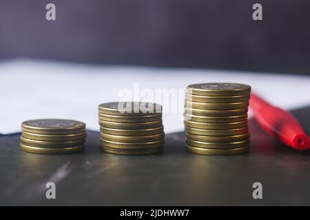 stack of coins, documents and pen on table  Stock Photo