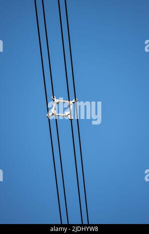 Close-up of the Spacers on a electricity lattice tower in the UK separating the high voltage cables. Stock Photo