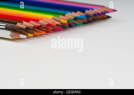 Female hand shakes the brush and soaks in watercolor paints. The photo  shows pencils, brushes, paints, pens and white paper Stock Photo - Alamy