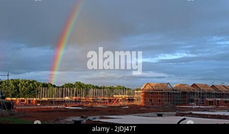 Rainbow over new property housing development, a mortgage pot of gold, Grappenhall Heys, Warrington, Cheshire, England, UK, WA4 3LH Stock Photo