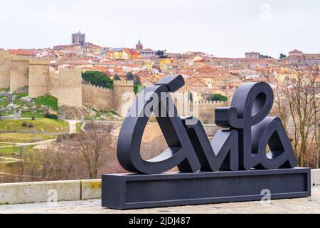 Avila city sign with background views of the walled city, Spain. Stock Photo