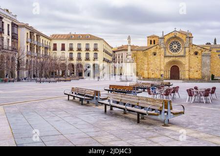 Large square with medieval church and old houses, benches to sit on, in the city of Avila, Spain. Stock Photo