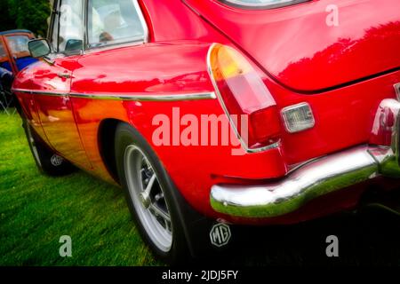 Retro styled image of a bright red classic vintage MG B sports car. Stock Photo