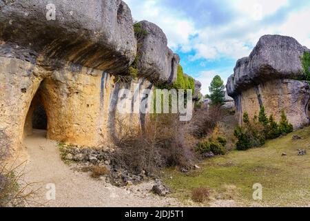 Large weathered rocks with tunnel formed in the huge weathered stone. Enchanted City of Cuenca. Stock Photo