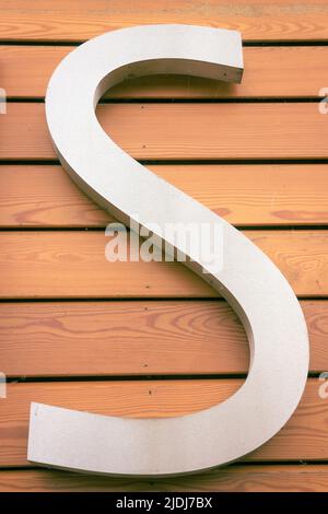 A capital letter S on the front of a public building. Stock Photo