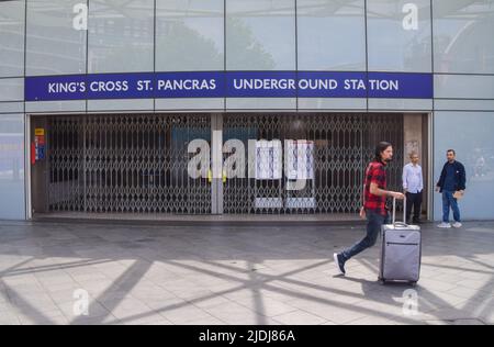 London, UK. 21st June 2022. A traveller passes by a closed entrance to King's Cross St Pancras Underground station, as the biggest nationwide rail strike in 30 years hits the UK. Stock Photo