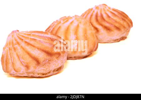 Three pink delicious appetizing profiterole eclair cakes on a white background Stock Photo