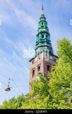 Looking up at the old tower and spire of the Nikolaj Contemporary Art Center (Kunsthallen Nikolaj) in Copenhagen, Denmark. Stock Photo